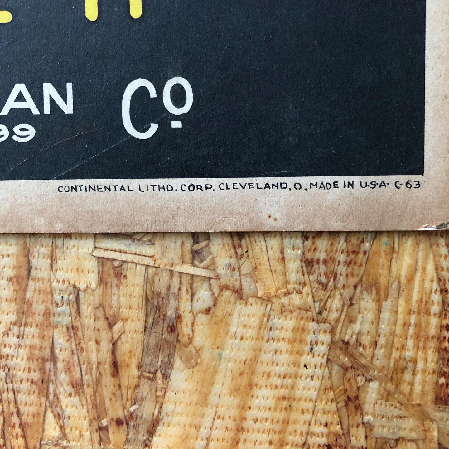Detail of the bottom edge: "CONTINENTAL LITHO. CORP. CLEVELAND, O. MADE IN U.S.A. C-63" printed in the cream border below the black field.
