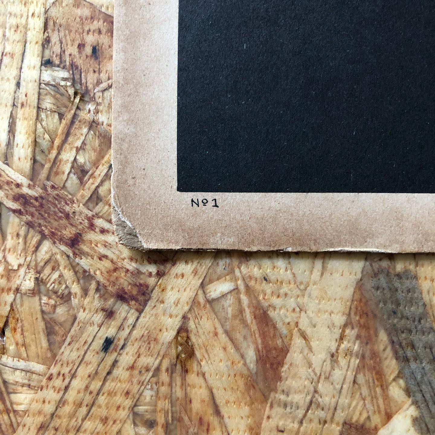Detail of the lower-left corner showing the hand-marked stock number "No. 1" on the cream border.