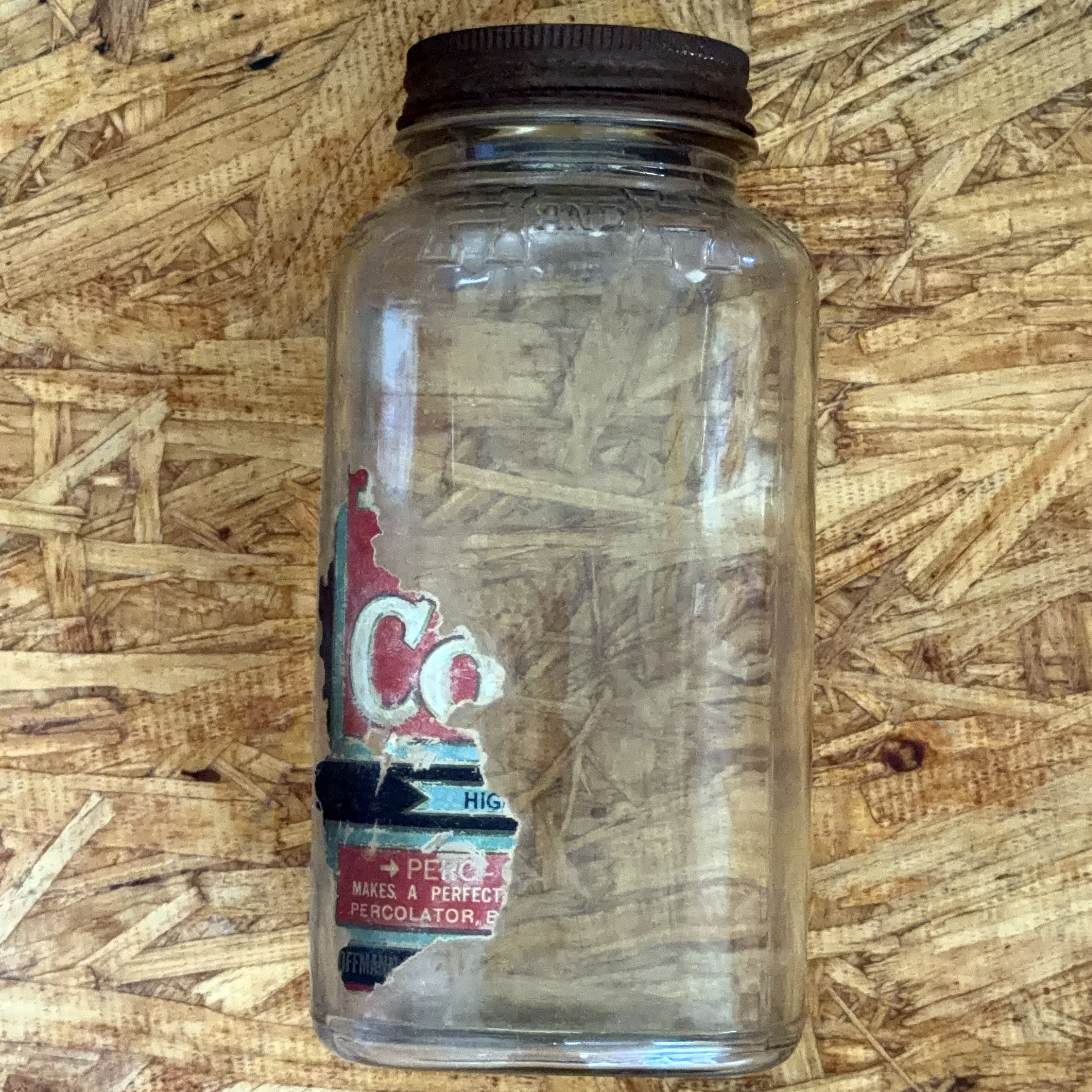 H and H Blend Coffee one-pound Crystalvac jar with brown screw lid and near-total paper label loss, surviving strip showing the PERC-O-DRIP GRIND panel, photographed 2026-07-21