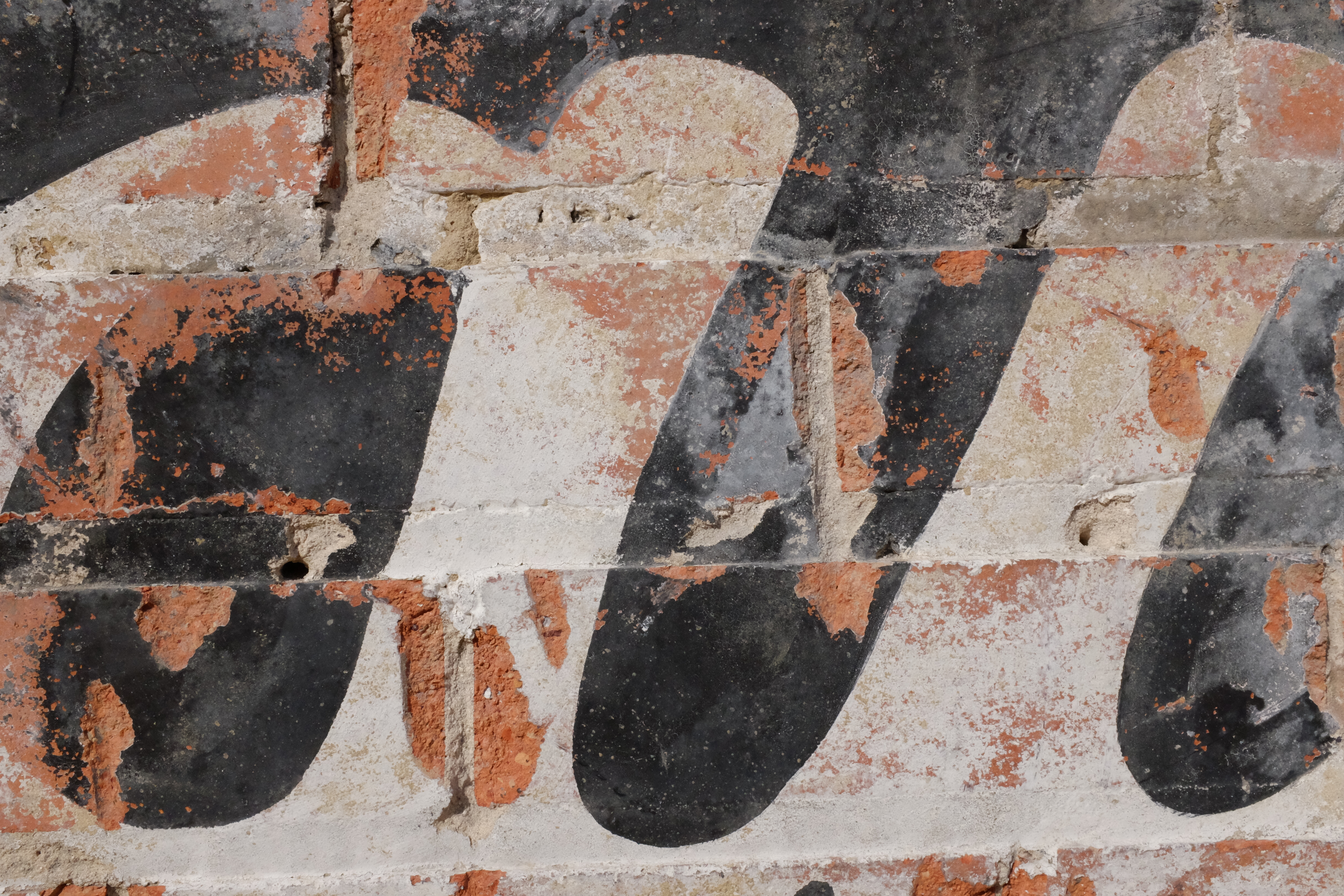Large black letterforms on chipped white ground — COFFEE-era stroke fragments