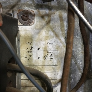 **8 March 2016** (**Apple iPhone 6s**) — oil-stained **paper chart** on **galvanized** machinery at Hoffmann-Hayman: printed columns **High** / **Deep**, pencilled **18**, **27×4¾**; heavy cables in frame — **shop measurement** retained on **process equipment**.