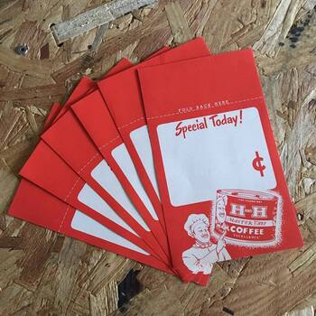 Collection photograph (**Instagram** media export **17859990502160676**) — high-angle fan of **six matching scarlet cardstock grocery counter cards** fanned across a rough **oriented-strand-board (OSB)** bench; each card carries a printed **'FOLD BACK HERE'** rule with **dashed cut guide**, a **white rounded-corner price panel** with red script **'Special Today!'** and an oversized **red cent (¢) sign**, a **white cartoon chef in toque** pointing upward at the blank price field, and a vignette **one-pound litho can** reading **ONE POUND NET**, **H AND H**, **MASTER CHEF**, **COFFEE**, **EXCELLENCE**; a **metal screw head** intrudes at **upper-left** — **in-store promotional price blanks in the Master Chef retail system**, matching graphics on **[contemporary pound tins](/assets/images/gallery/master-chef-1-pound-tin.jpg)** in **this gallery**