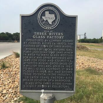Field photograph of the **Texas Historical Commission** historical marker for the **Three Rivers Glass Company** (**circa 1920–1936**) at **Three Rivers, Texas** — the **South Texas glasshouse** whose **square vacuum jars** (**Crystalvac** packaging family) and other bottles **Hoffmann-Hayman** filled in San Antonio; **supplier-plant documentation** on **location**, **not** a photograph of the **Delaware Street coffee factory** itself — project reference frame (**Instagram 2017** outing; companion copy on **[Three Rivers Glass bottles]({{ site.baseurl }}/bottles/)**)